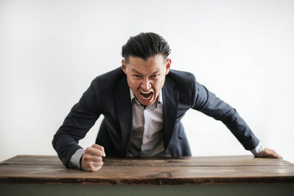 Man Bangs the table in anger