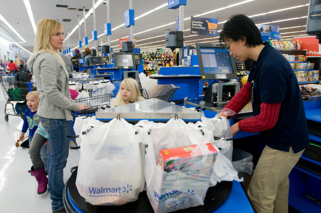 Family checking out their purchase with a Walmart cashier