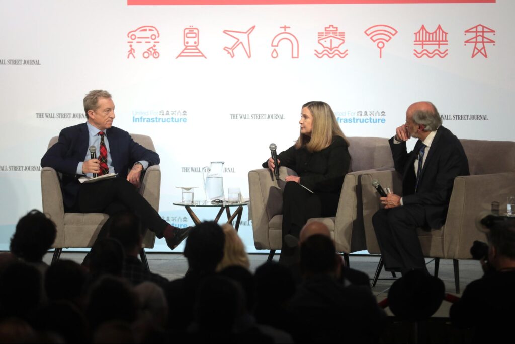 Three panelists speaking with attendees at the Moving America Forward Forum