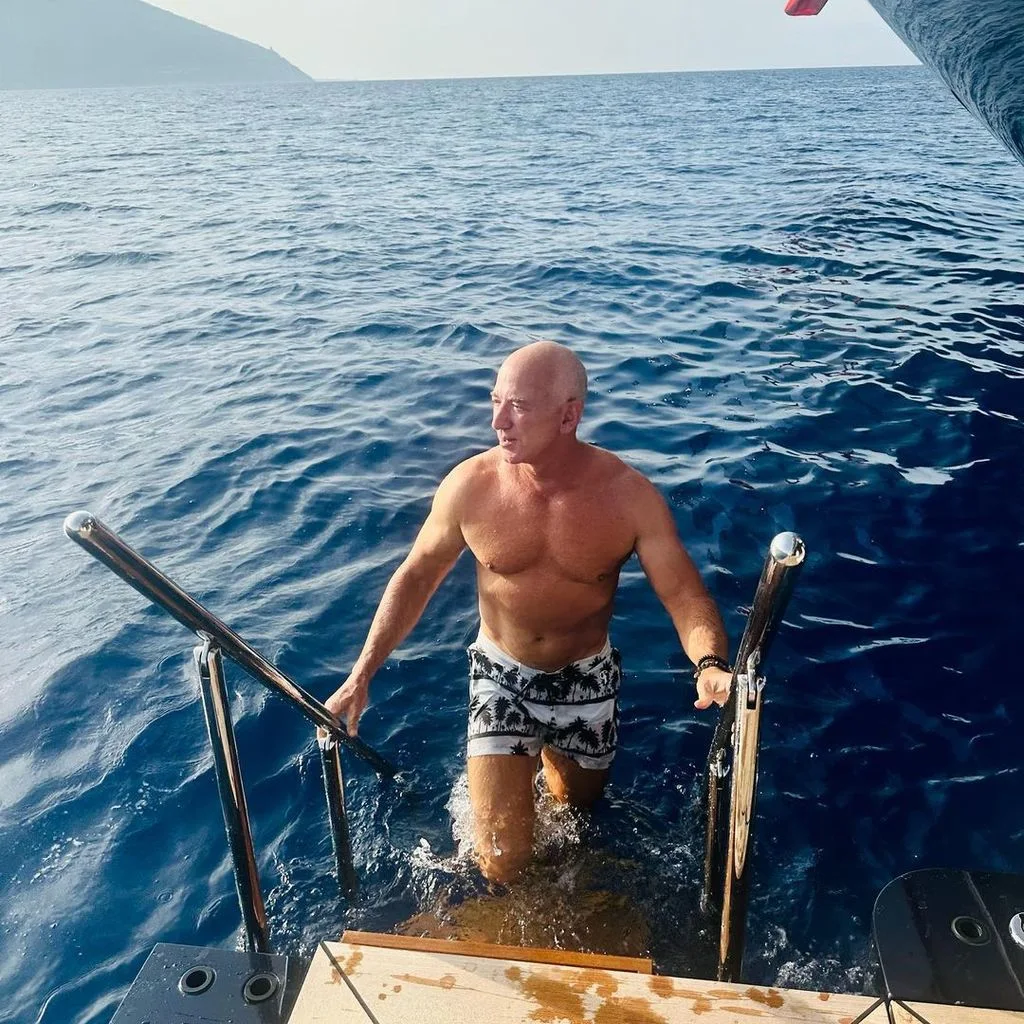 Bezos coming aboard his yacht after a swim