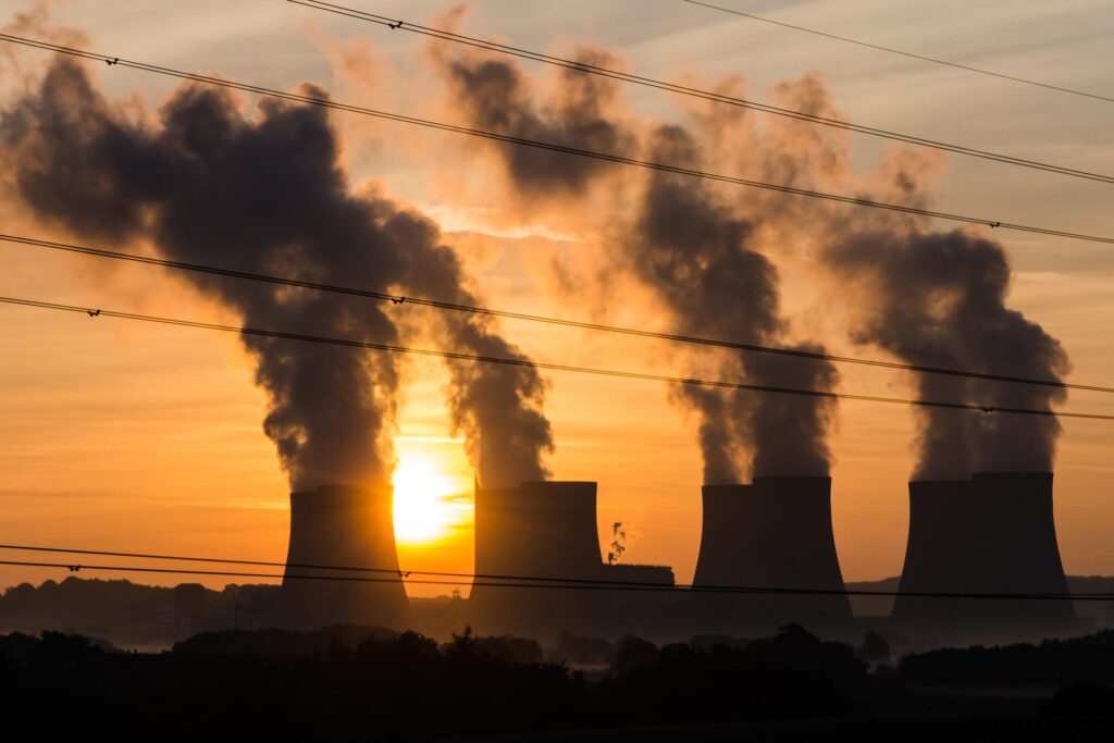 Plumes of smoke rising to the sky from a power plant