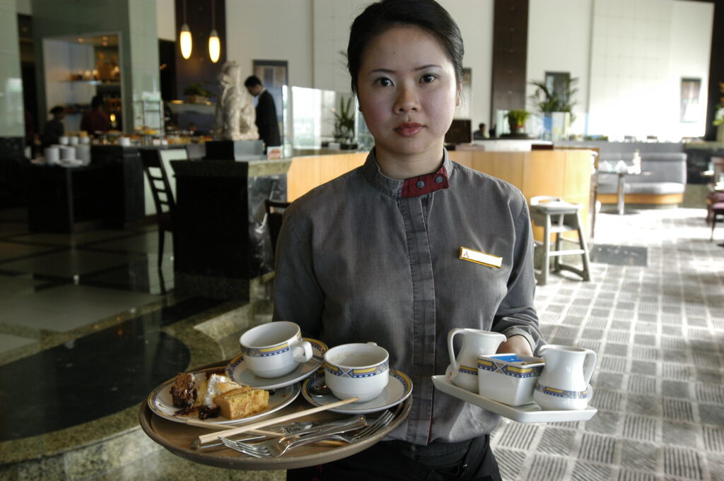 A waiter, after clearing a table