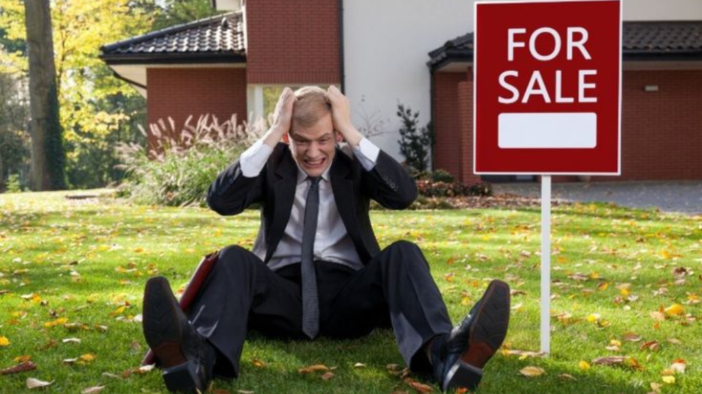 Frustrated man in front of a house on sale