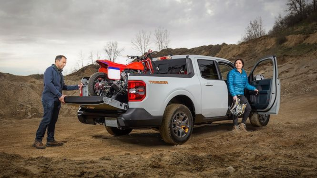 Couple with their Ford Maverick pickup truck