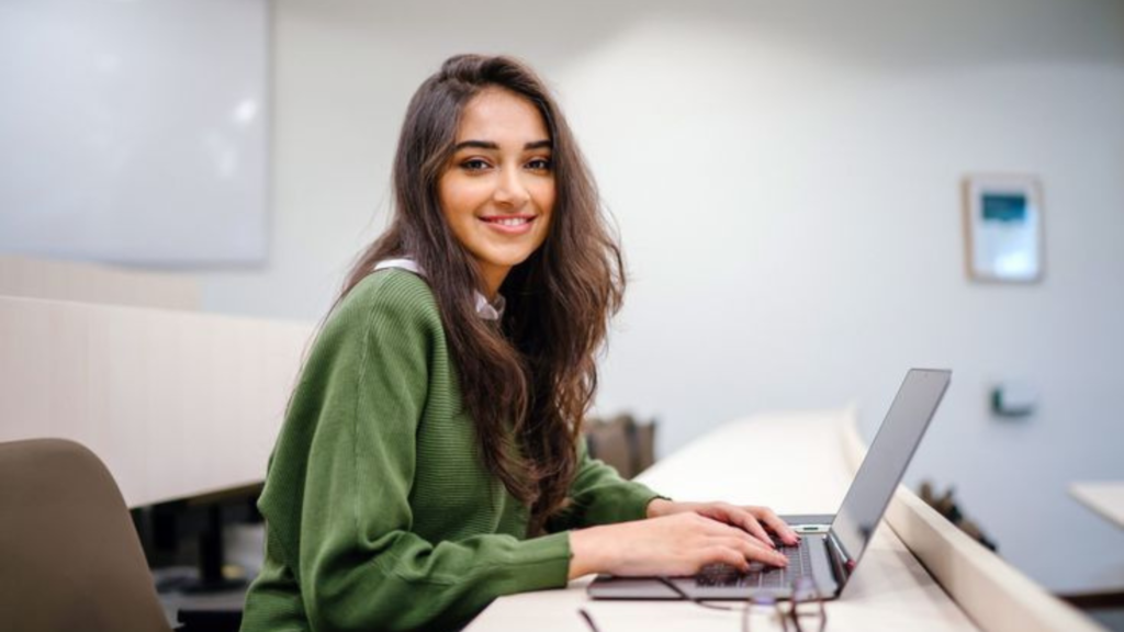 A teenager working on her laptop