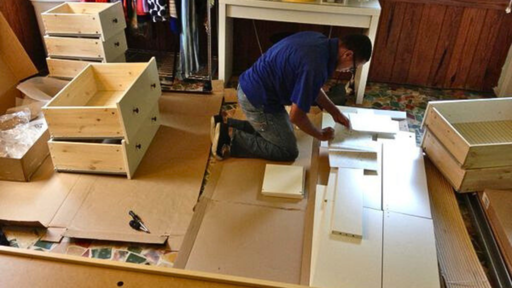 A man assembling IKEA furniture