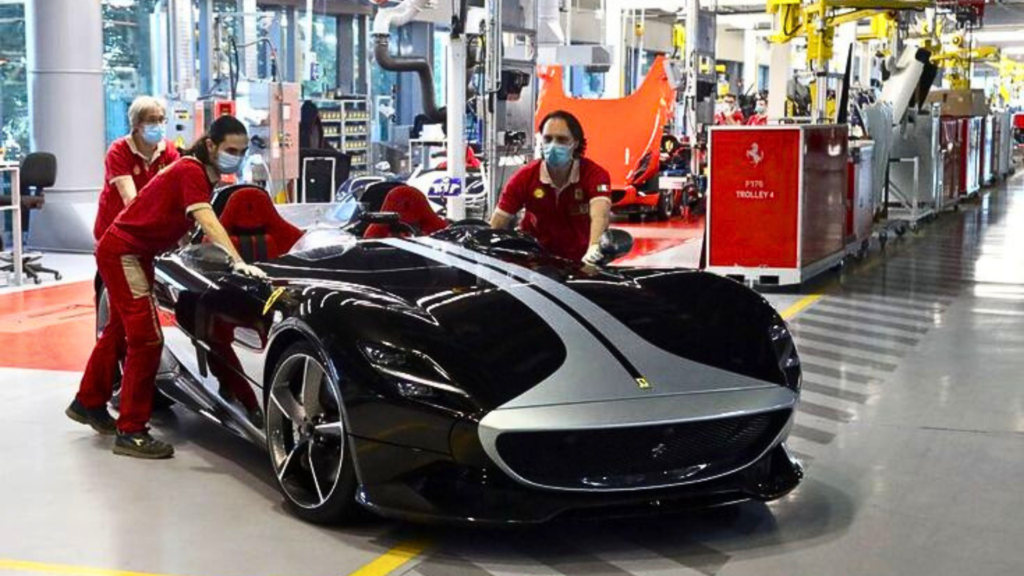 Ferrari employees positioning car