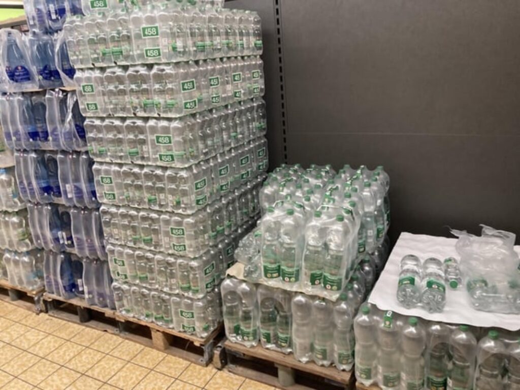 Packs of bottled water in a store