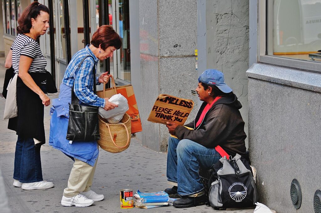 Two Elderly Women Helping Out a Homeless Man