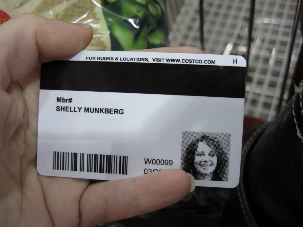 Lady showing photo on her Costco card