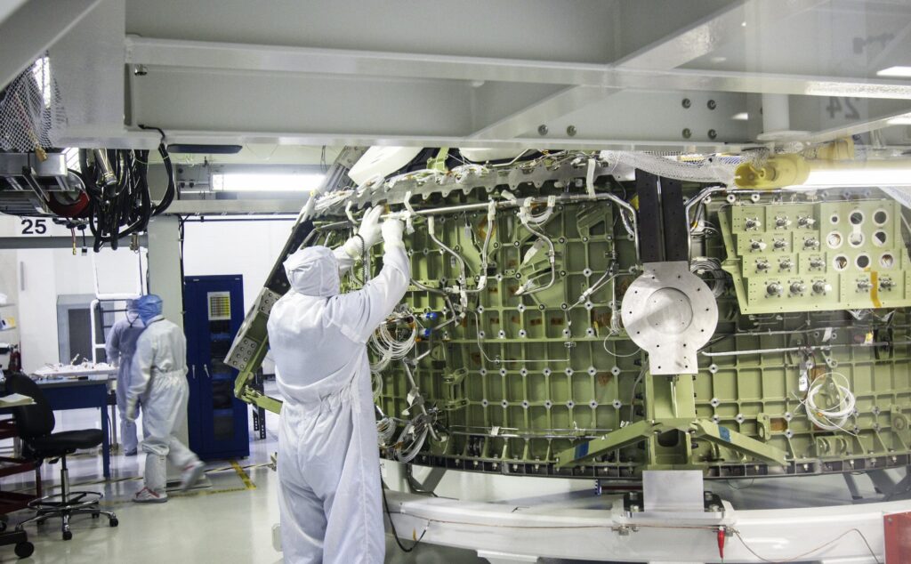 Technicians working on the Orion crew module