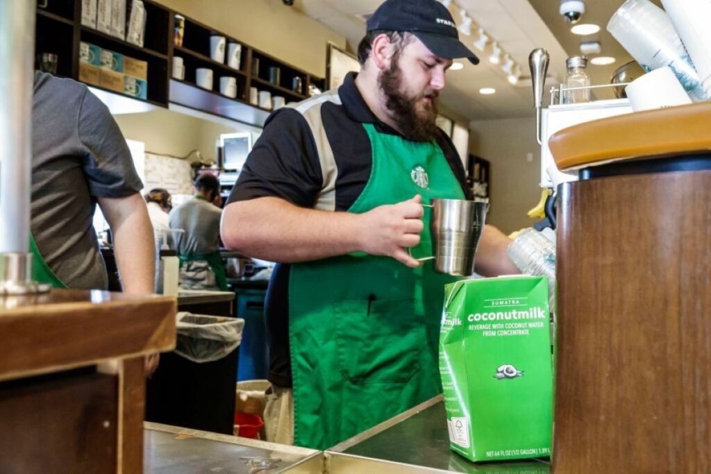 A Starbucks barista attending to a customer