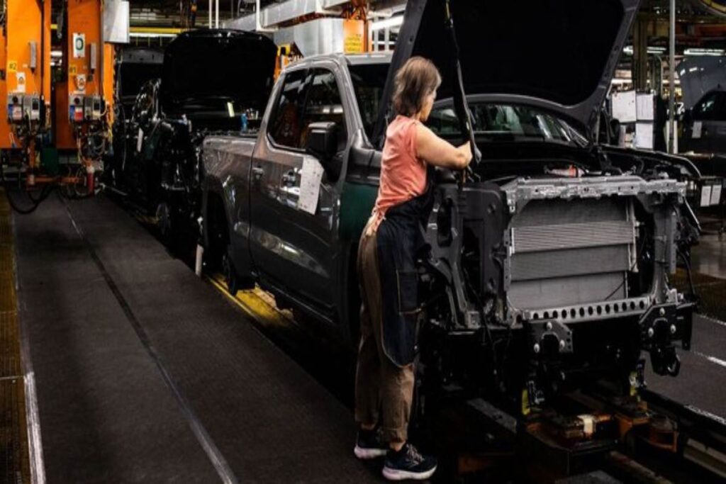 Woman working on a GM assembly line