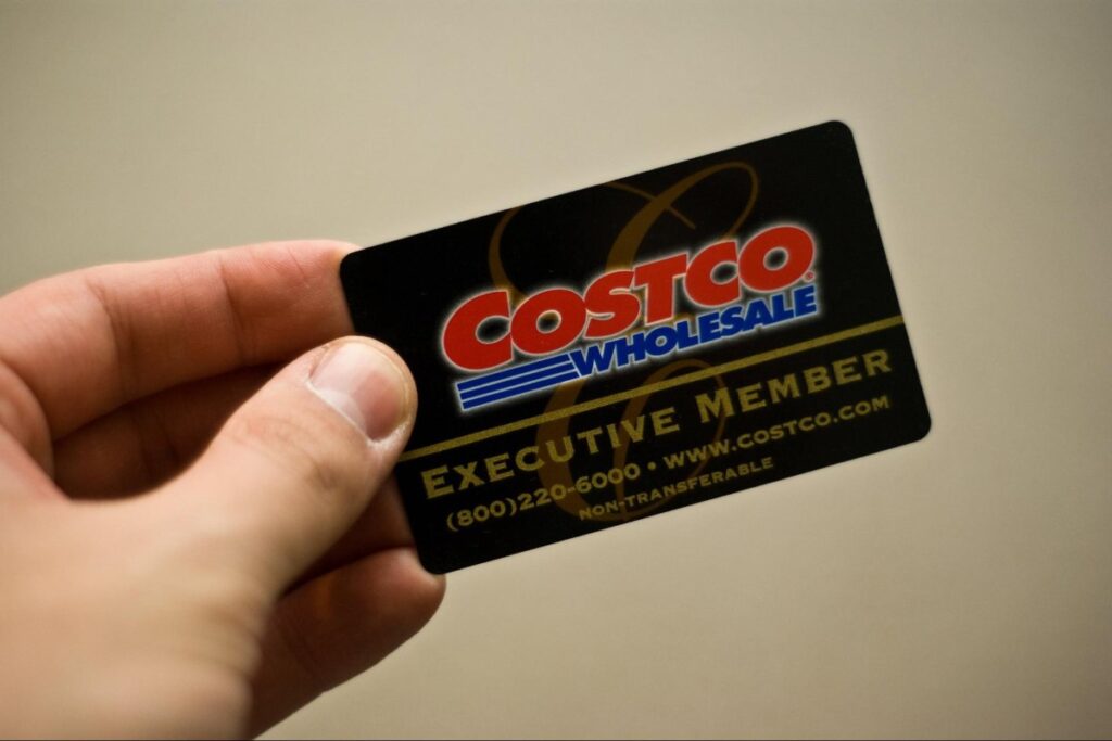 Costco shopper holding a membership card