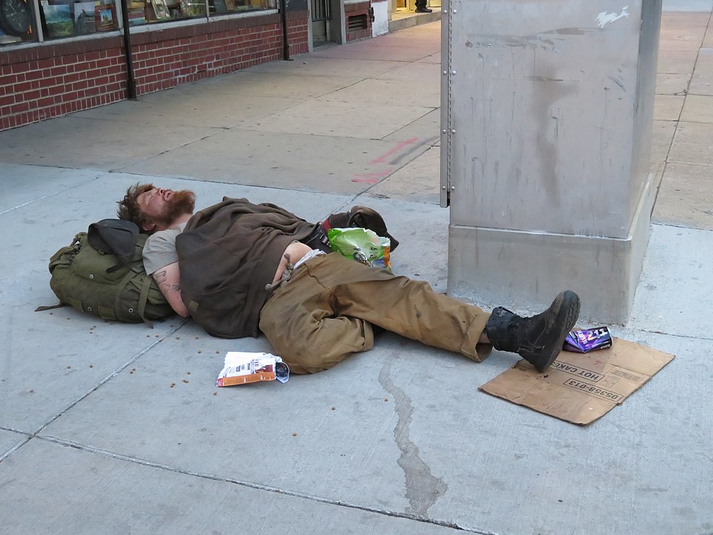 A homeless man sleeping across the street from the Colorado State Capitol.