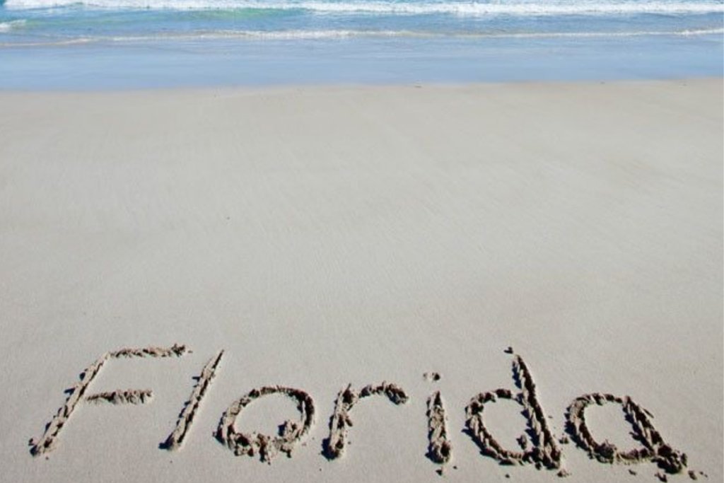 An image showing the word “Florida” drawn in the sand