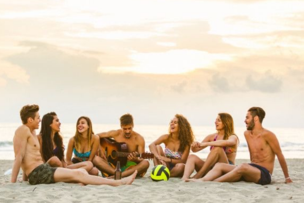 An image of young people on the beach