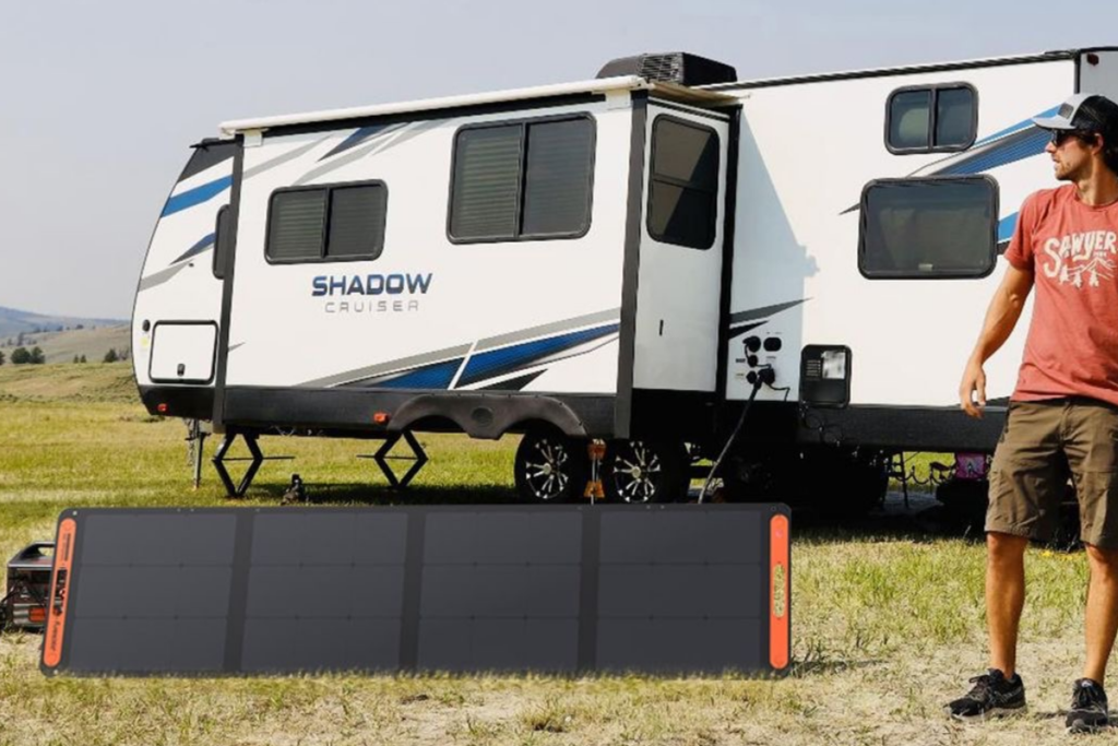 An image of portable solar panels and a camp truck