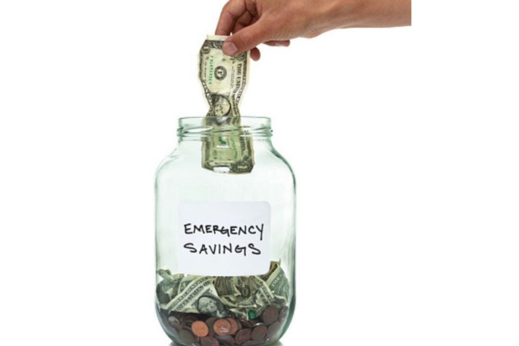 An image showing a jar of emergency savings and a hand put in money in it