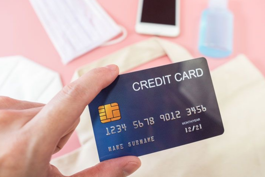 An image of someone holding a credit card