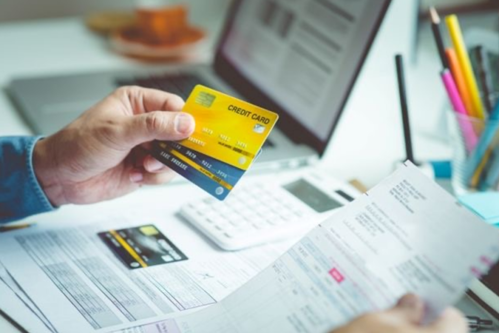 An image of a person holding credit cards