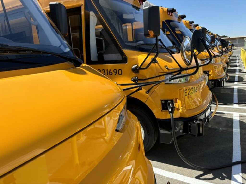 Electric buses parked to charge in a lot