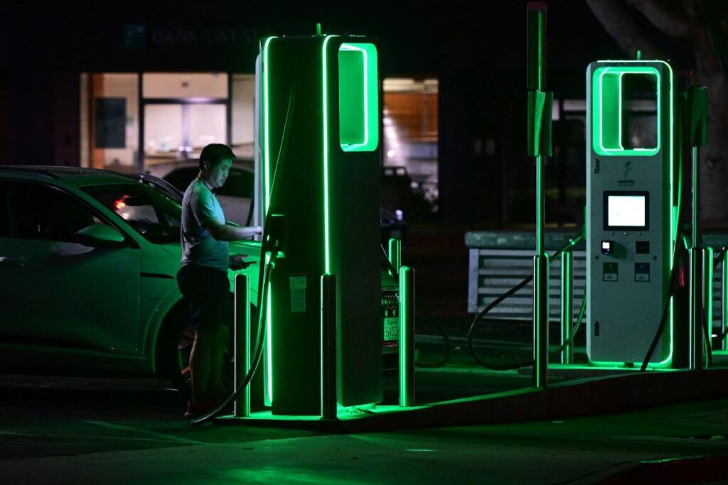 Man in a charging station at night