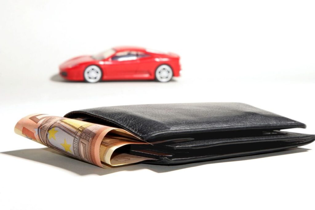 Wallet with some loose currencies and model car inset