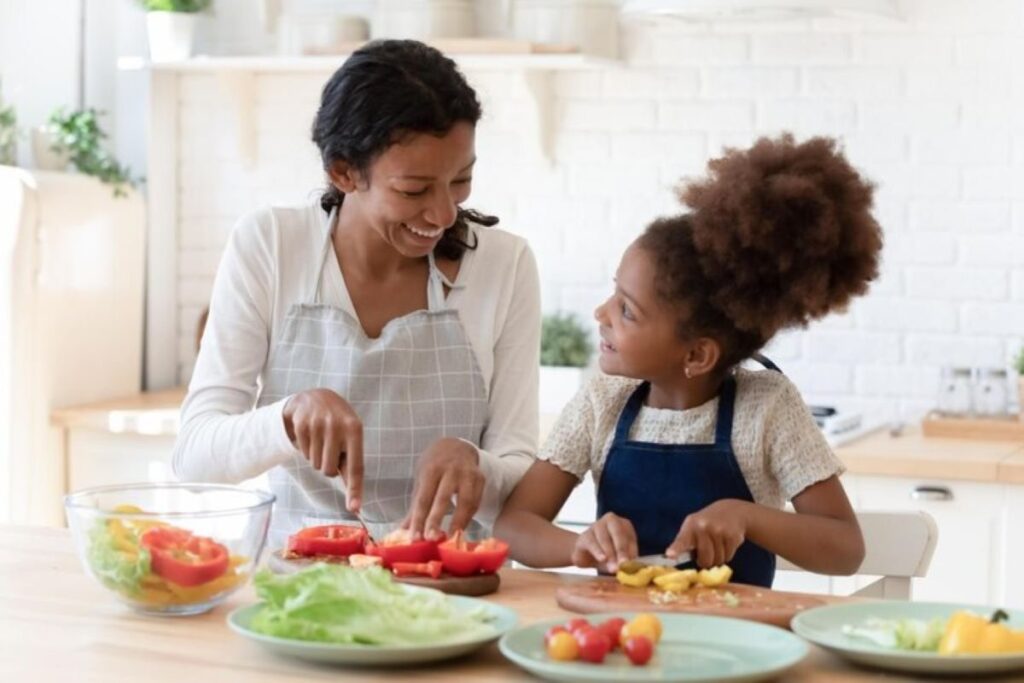 A woman and a girl bonding in the kitchen