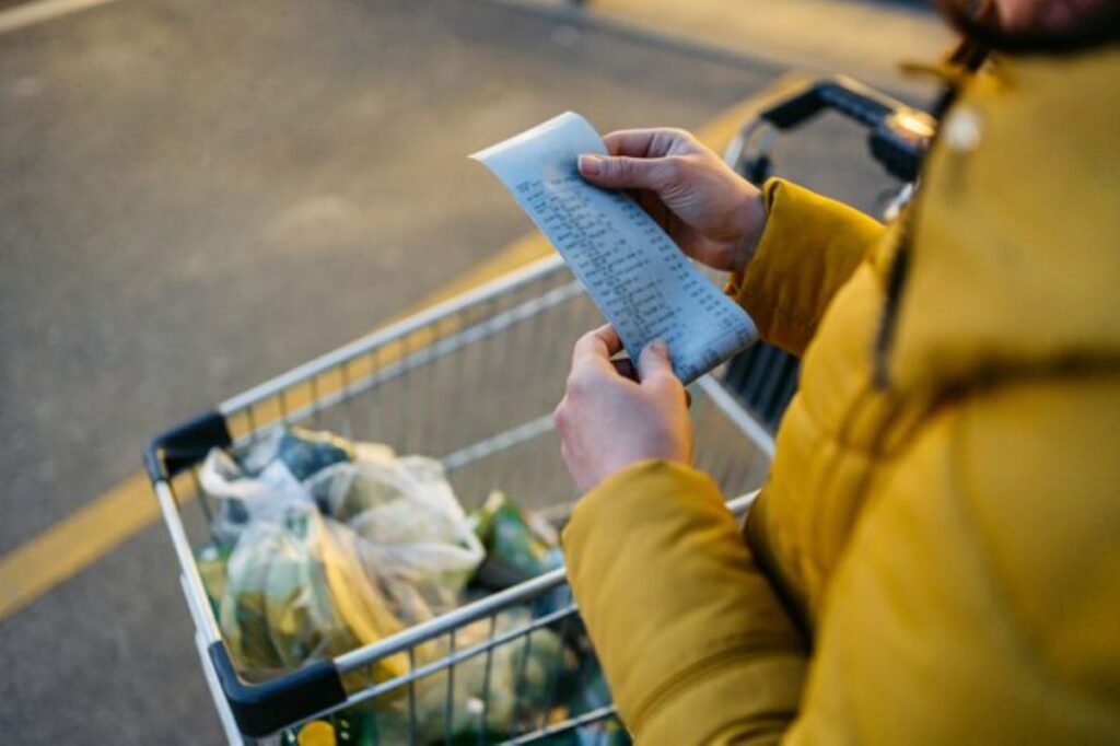 Grocery shopper going through the bill