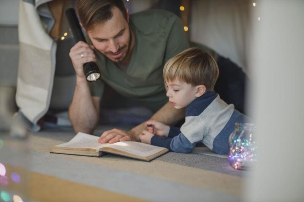 A man reading with his son