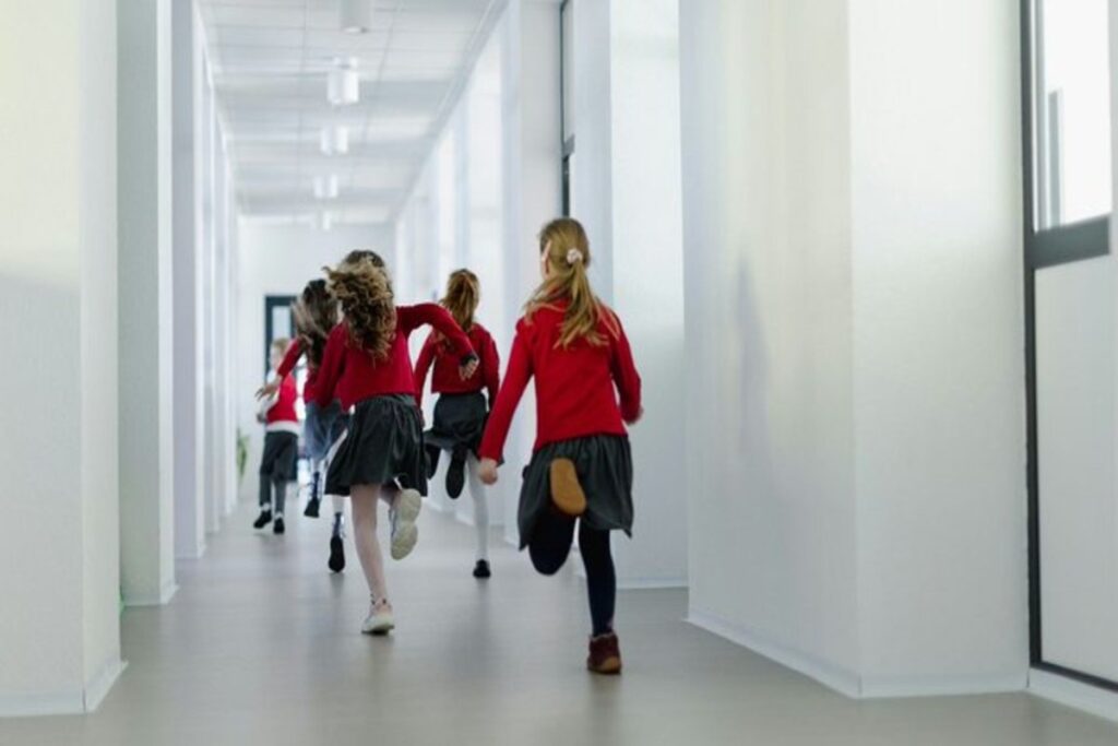 School children running through a corridor