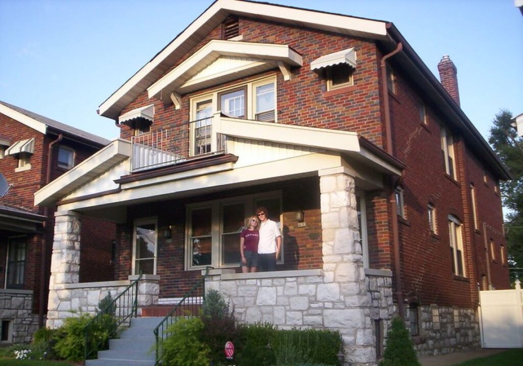 Young couple on the porch of their new home