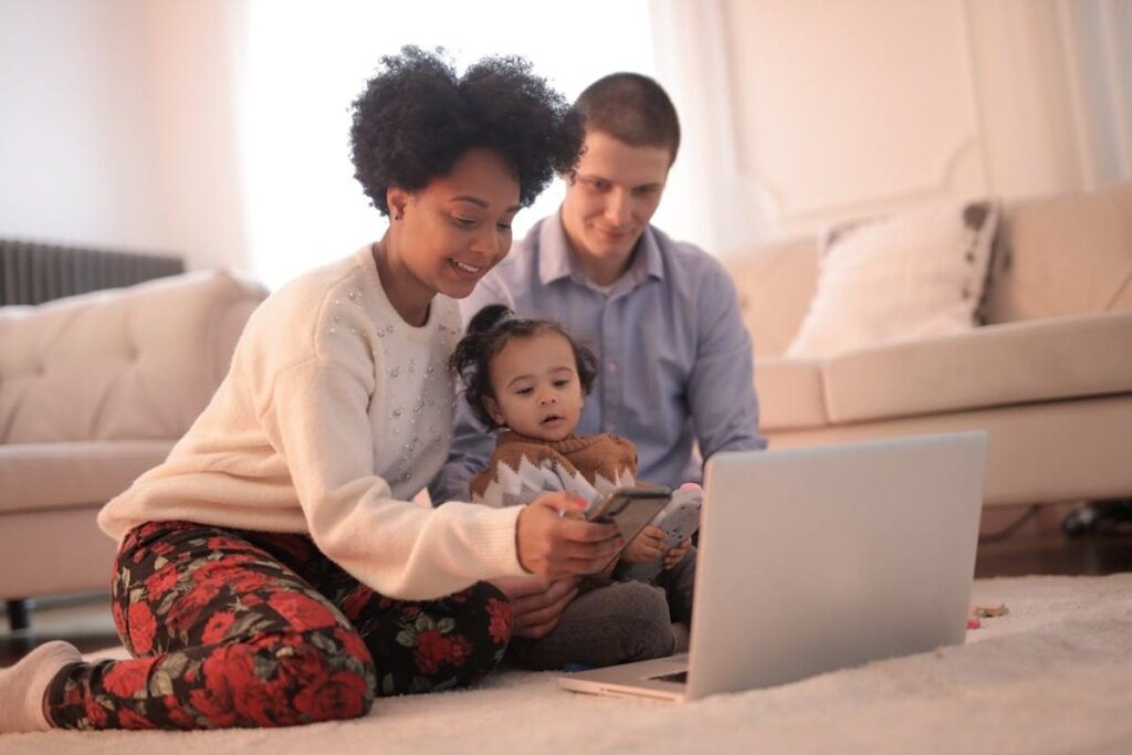 Woman Using Smartphone While Sitting Near Her Baby