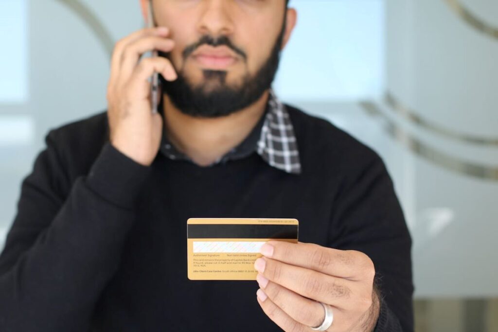 Close-Up Shot of a Man Holding a Credit Card 