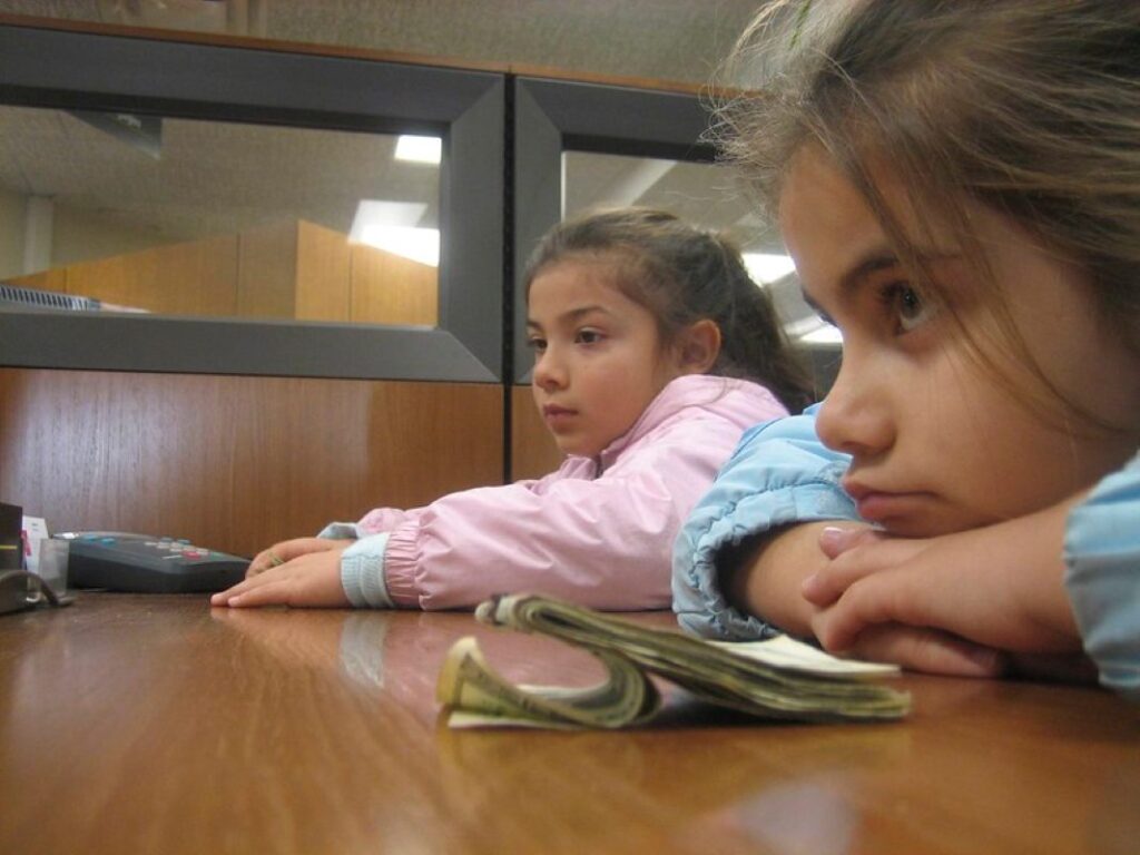 Children at the bank trying to save