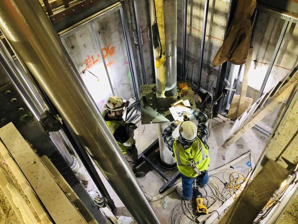 Technicians installing an elevator 