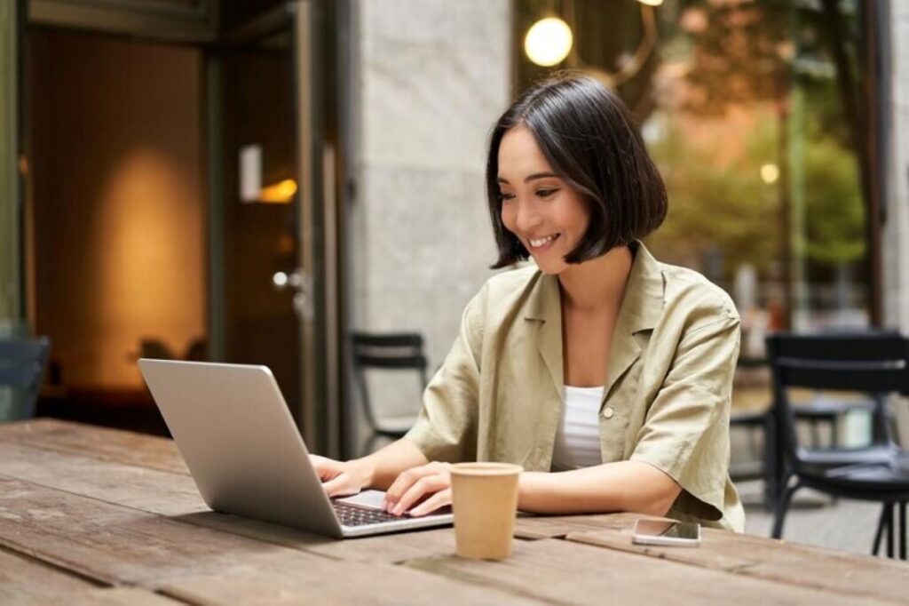 A lady writing on her laptop