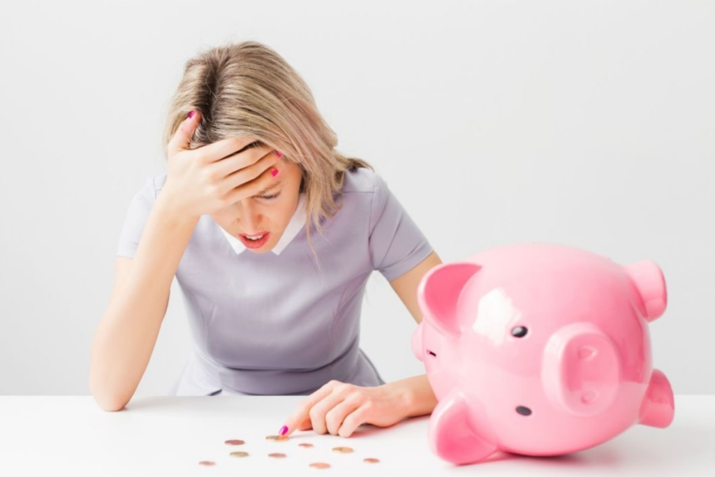 An image of a lady counting coins with a piggy bank on the table