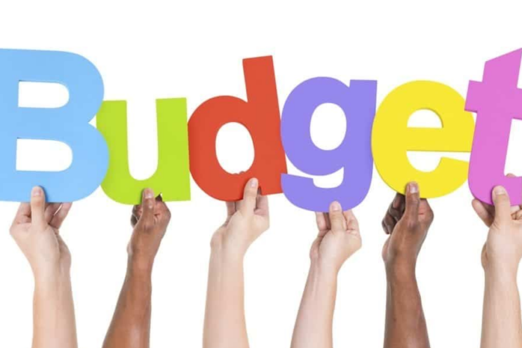 An image of hands holding letters that spell the word “budget”