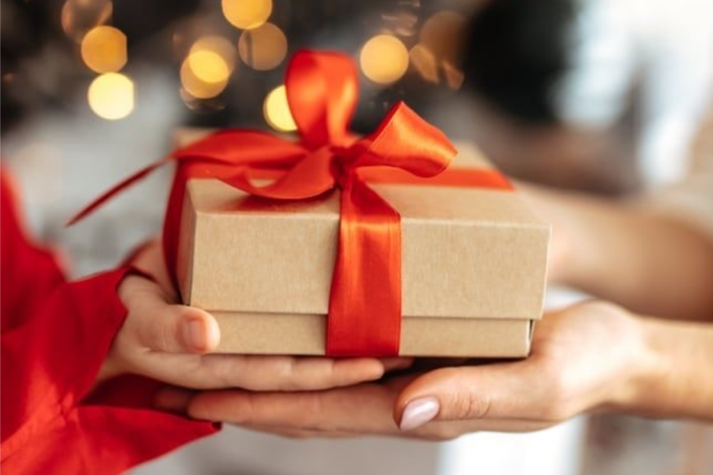 An image of two people holding a gift