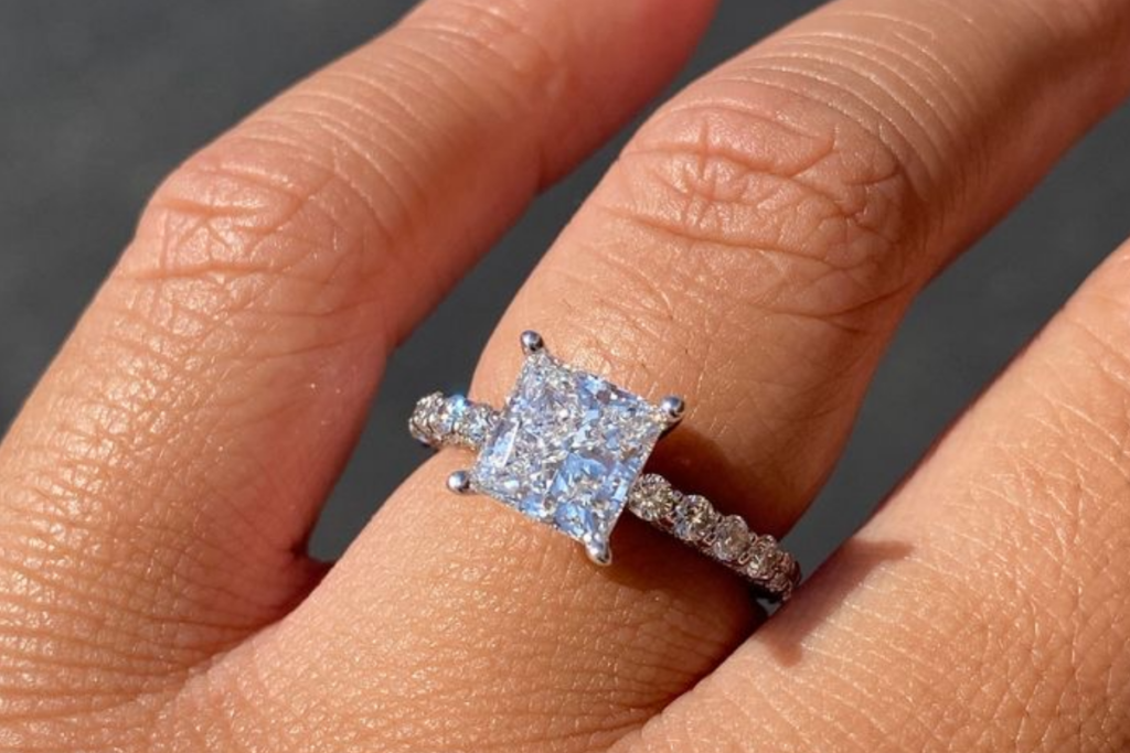 An image of a diamond ring on a finger