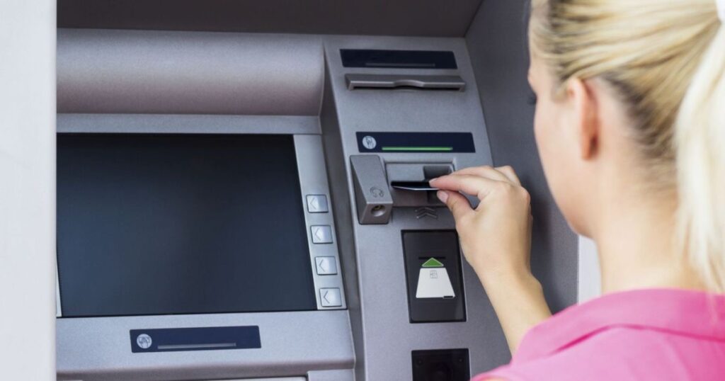 An image of a woman trying to  withdraw money