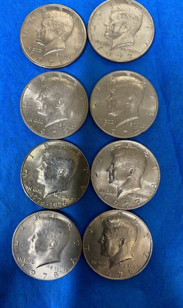 An image of Kennedy half dollar coins