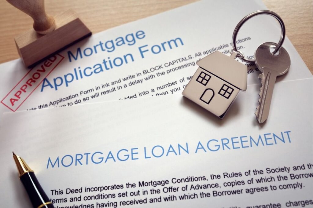 An image of a mortgage application form with house keys on it