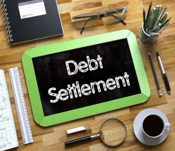 An image showing “Debt Settlement” on a board