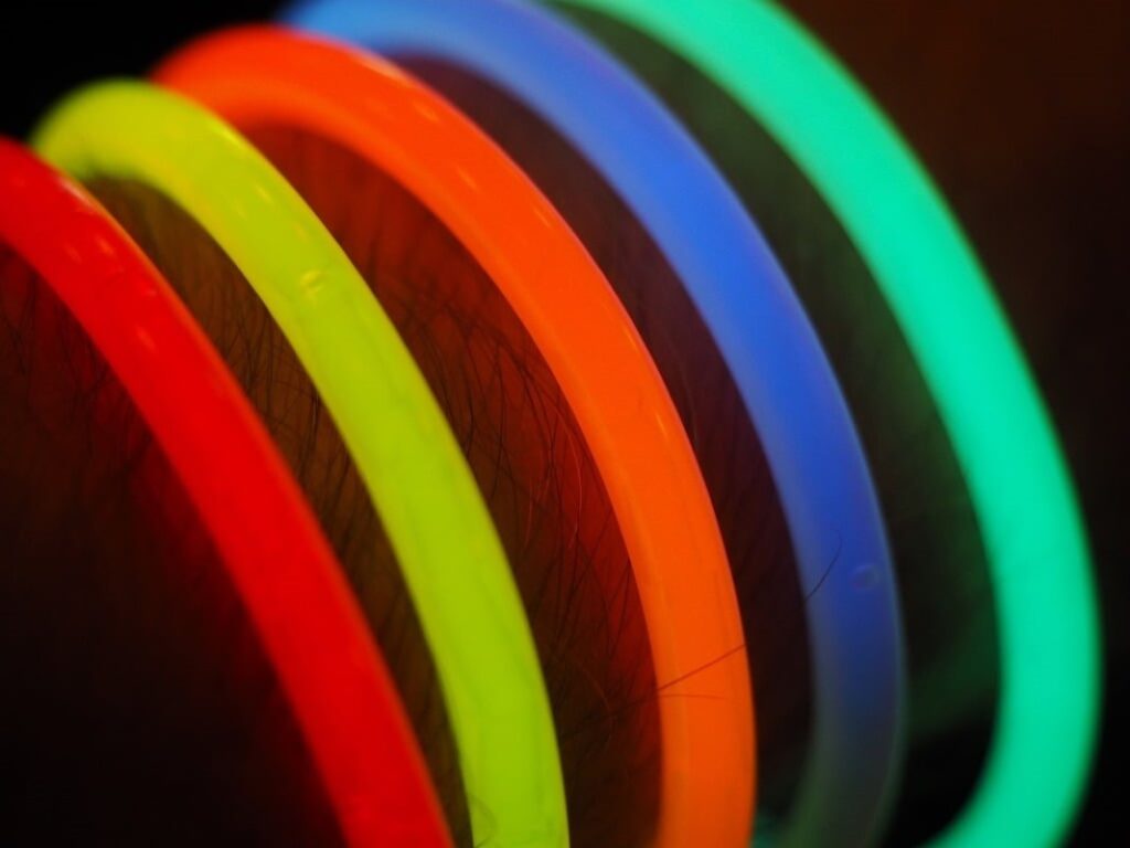 Neon bracelets glowing in the dark