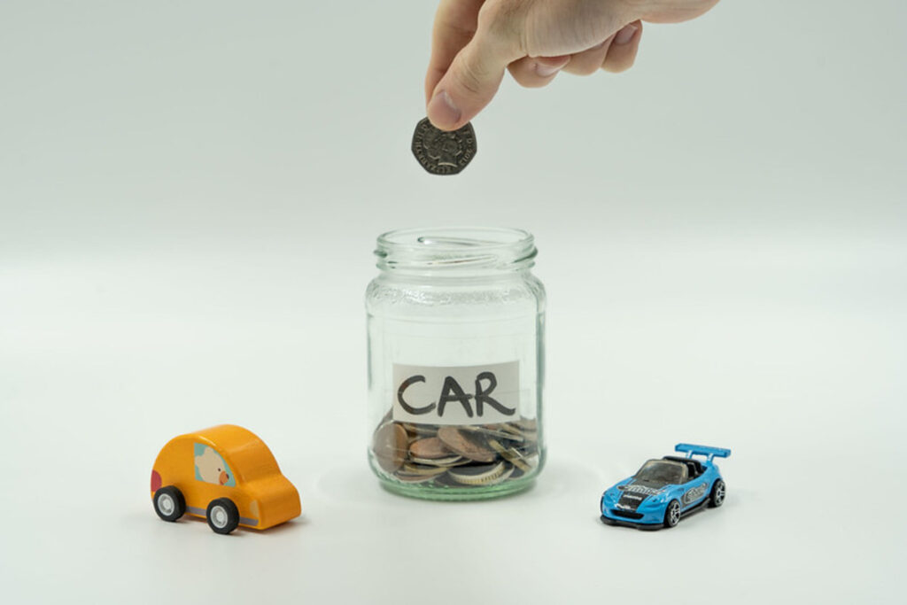 A coin jar and two model cars