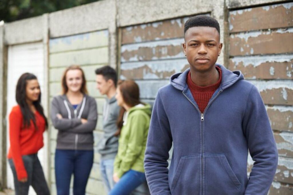 A young man with some peers in set