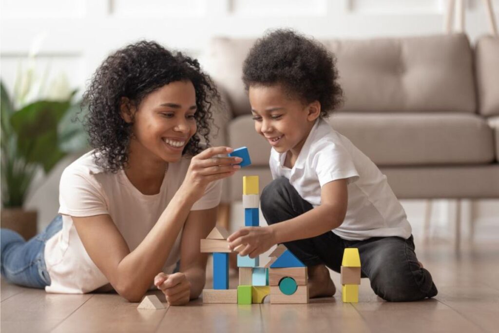 A woman and a kid playing a brick game